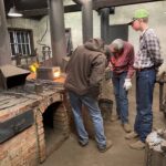 Teacher and master craftsman Caleb explaining the heating process