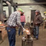 Student striking the hot iron